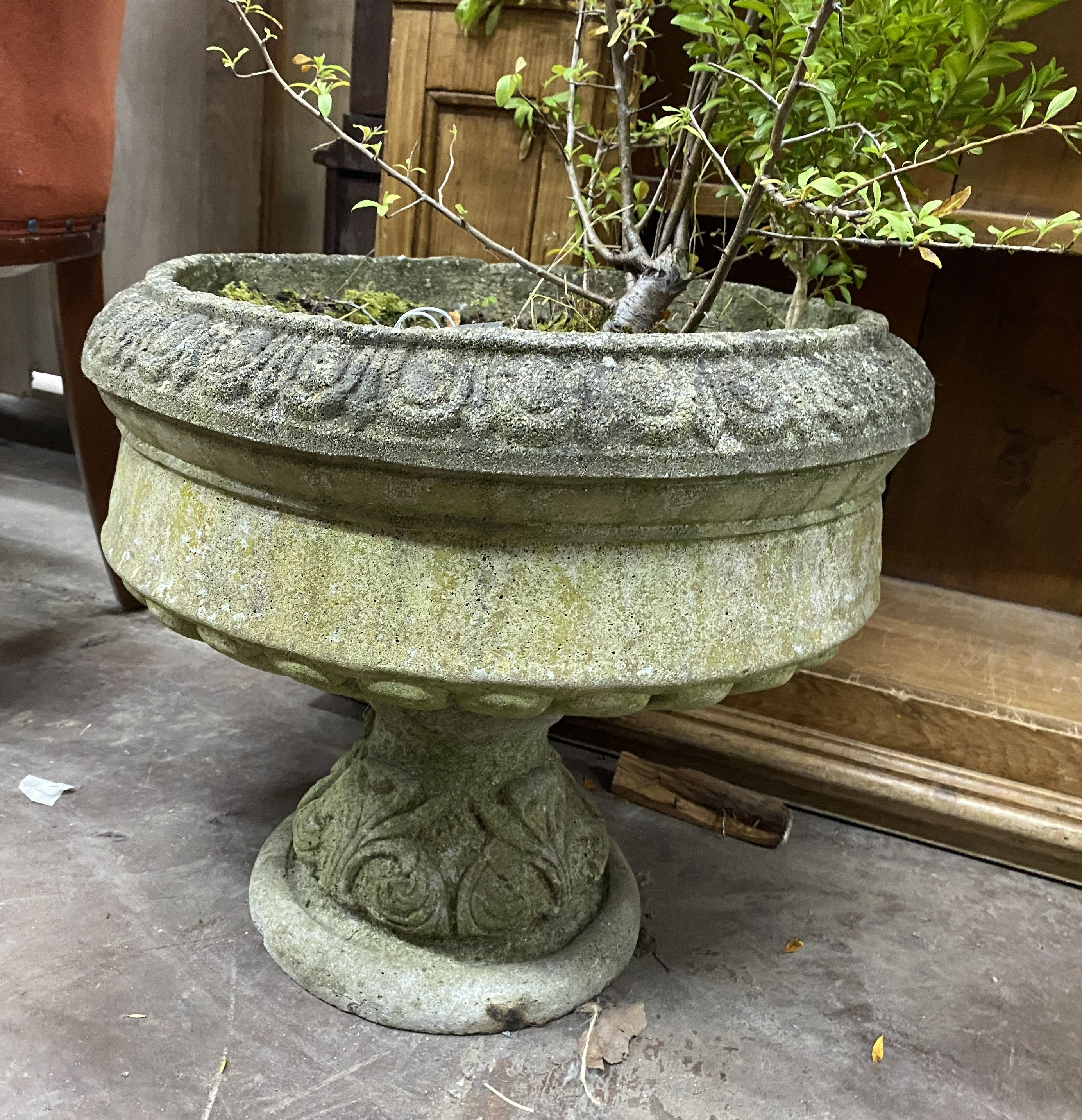 A circular reconstituted stone garden planter, diameter 40cm, height 38cm